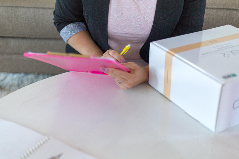 A person filling in a clipboard checklist