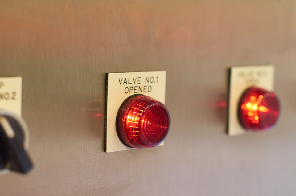 Red indicator lights on an industrial control panel
